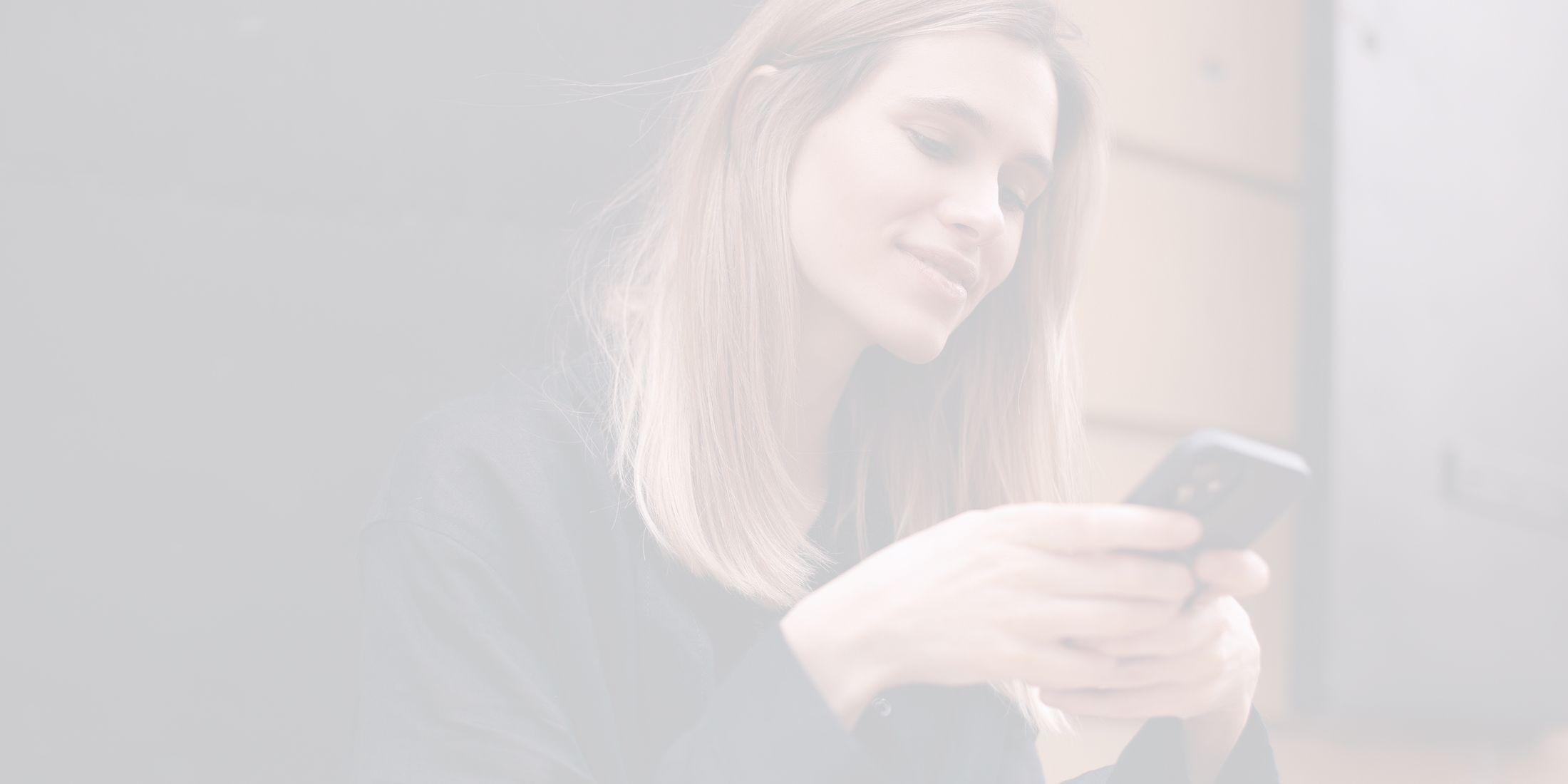 Woman interacting with smartphone, smiling contently.