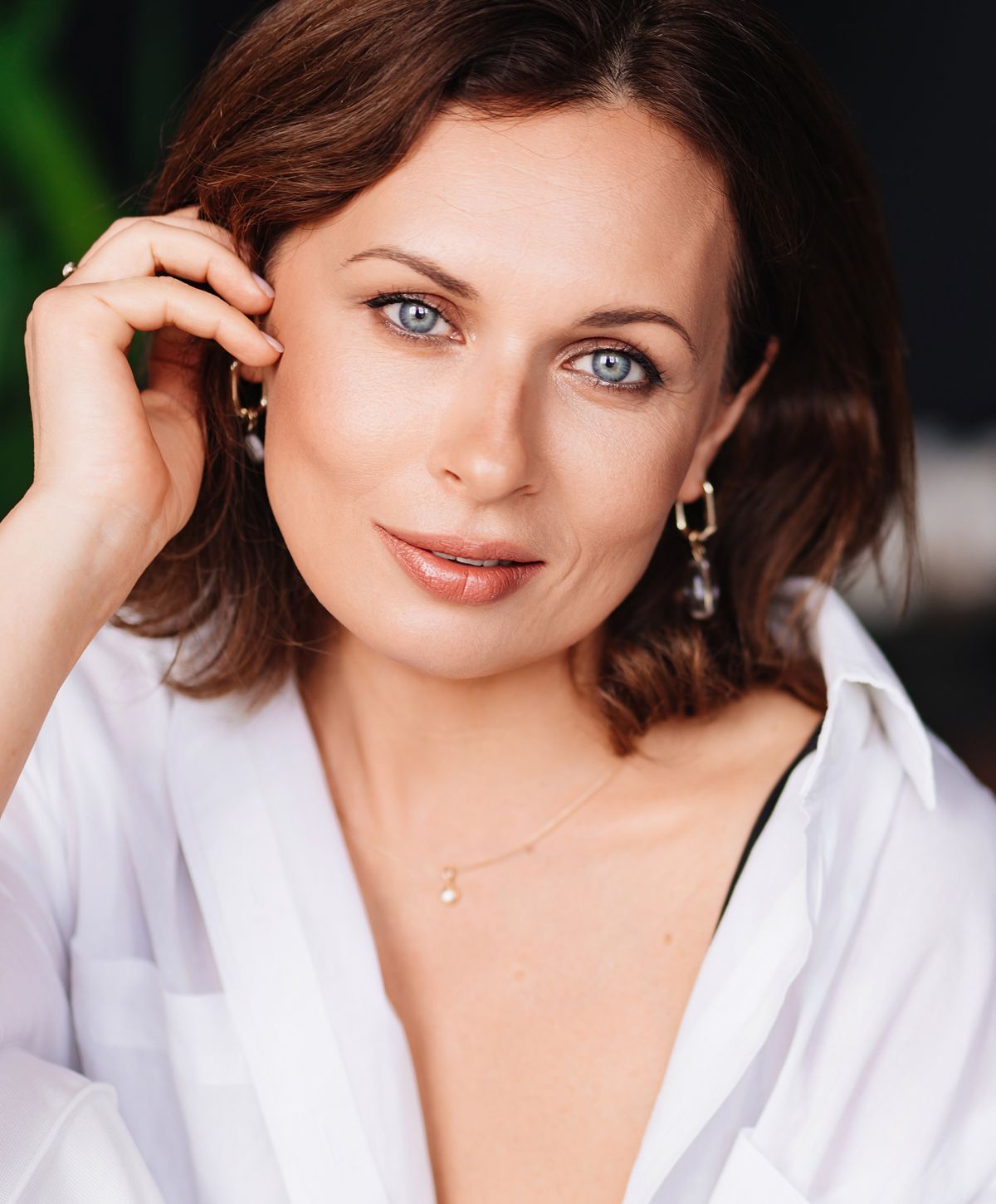 Close-up of woman with blue eyes and smile.