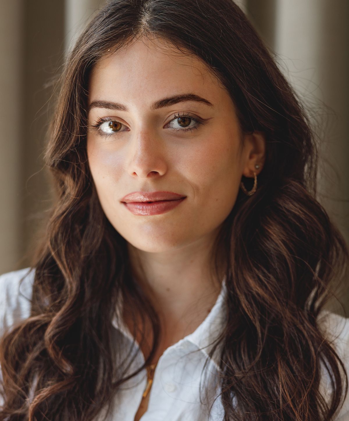 Portrait of a woman with long, wavy hair.
