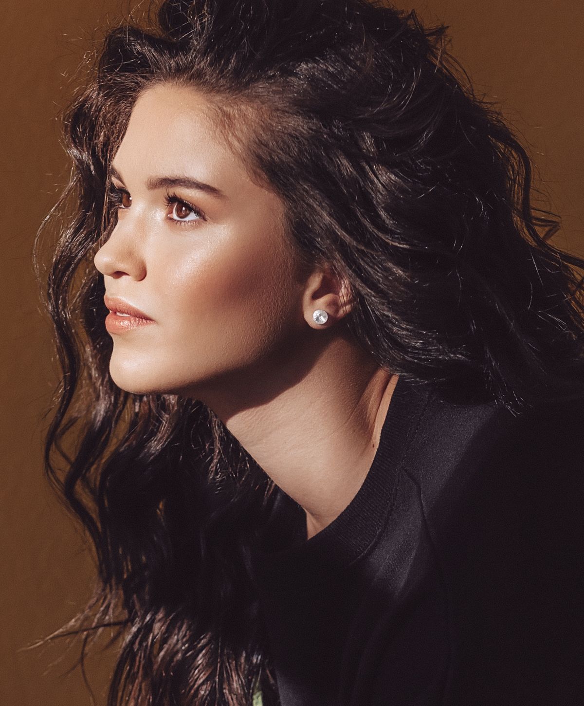 Woman with short hair in soft sunlight.