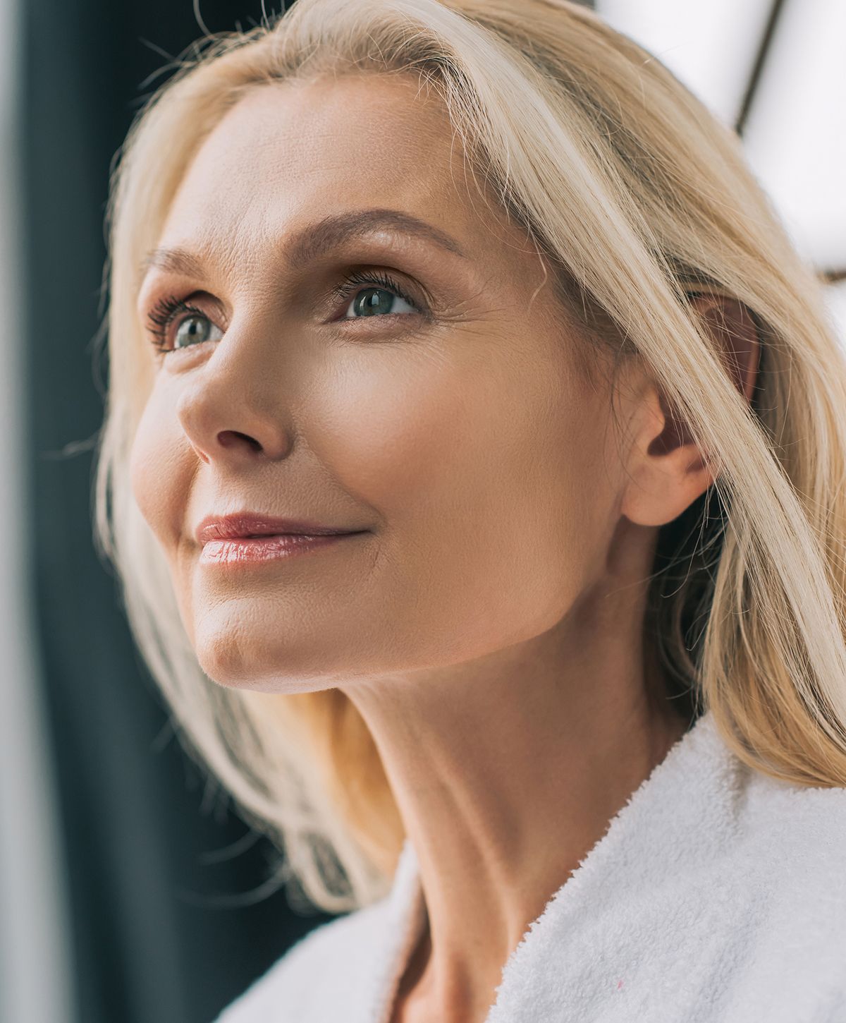 Woman with long, wavy hair and stylish outfit.