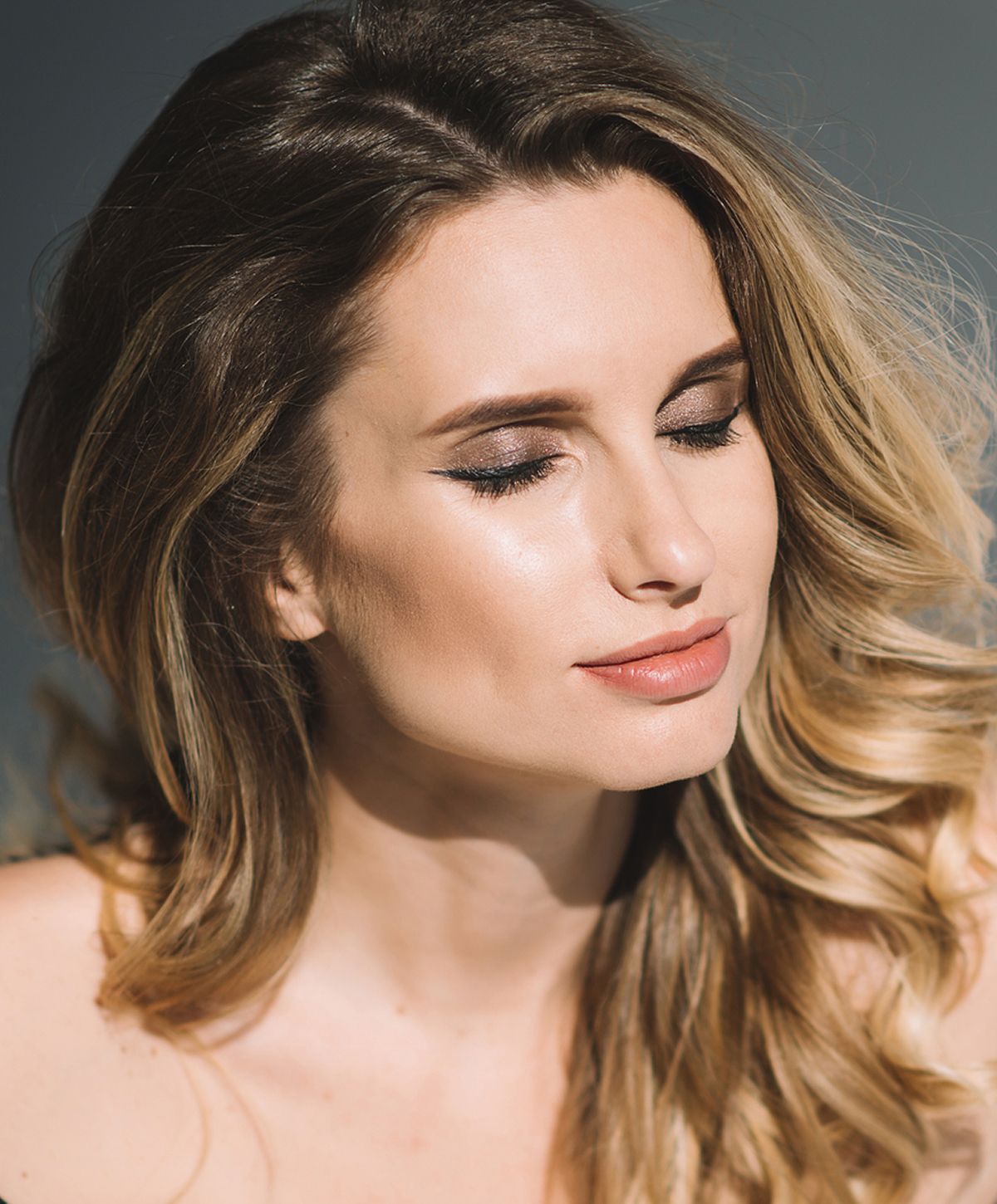 Woman with short hair in soft sunlight.