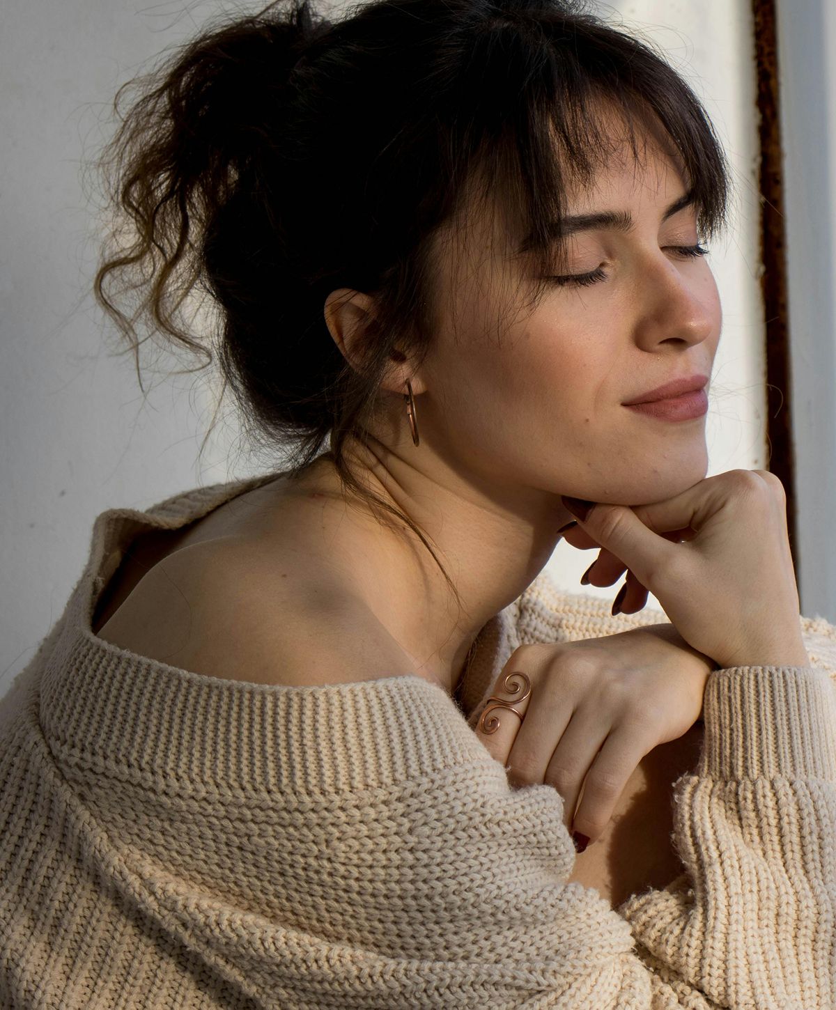 Woman with short hair in soft sunlight.