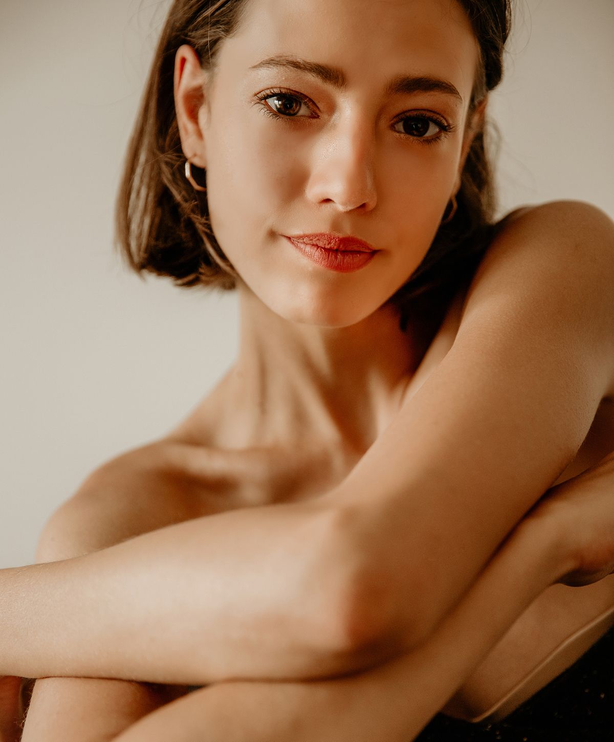 Woman with long, wavy hair and stylish outfit.