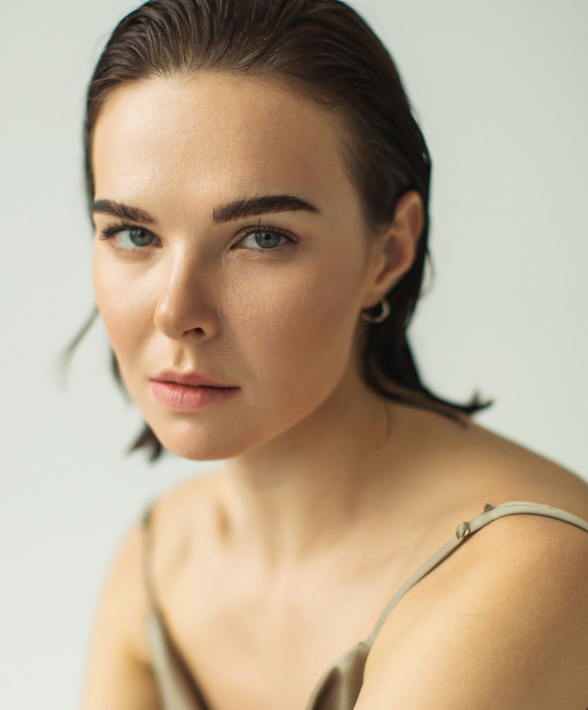 Woman with short hair in soft sunlight.