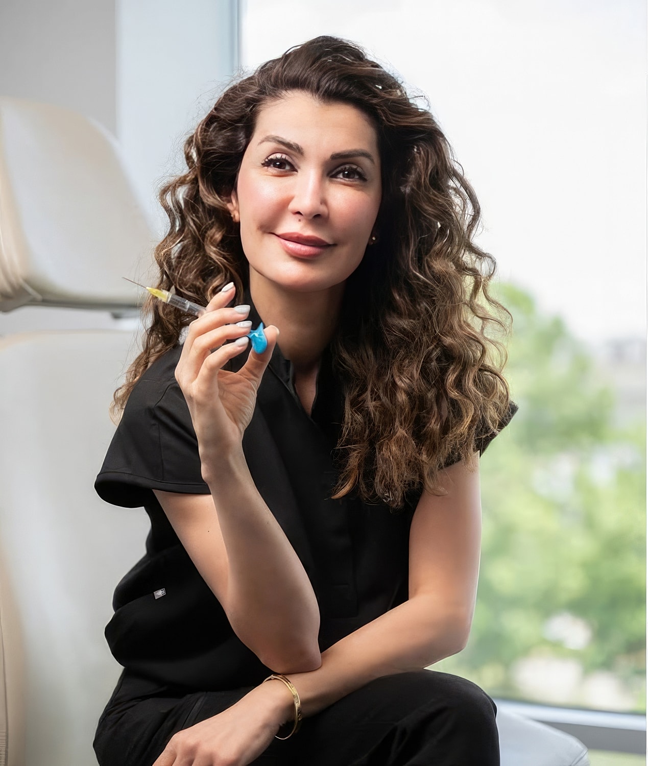 Healthcare professional holding a syringe, smiling.