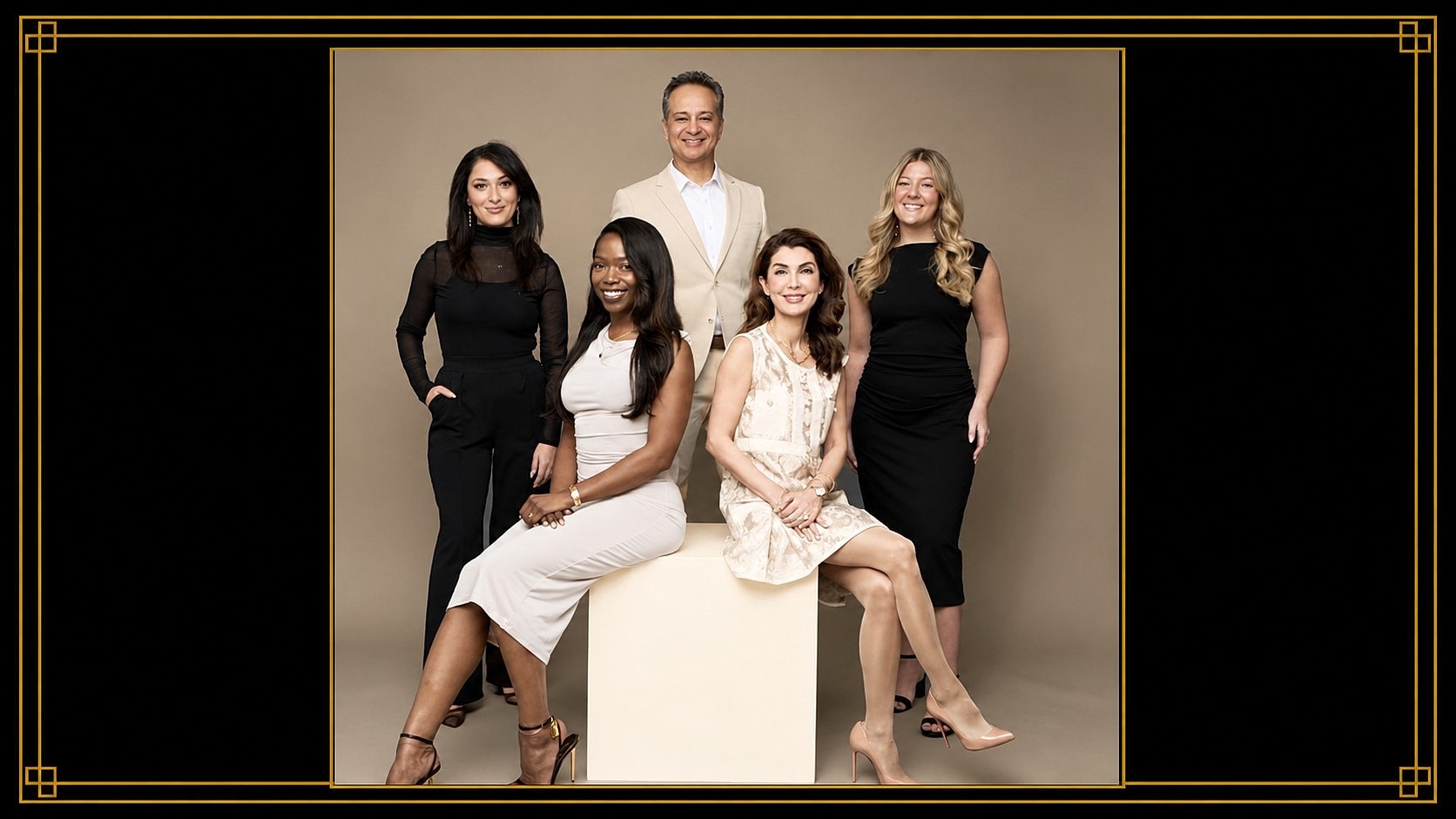 Group portrait of five individuals in professional attire.