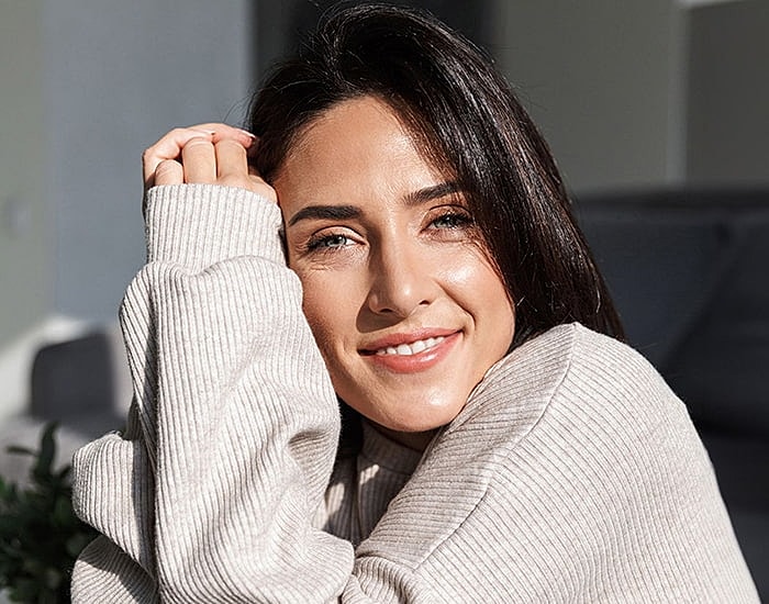 Woman with long hair looking over her shoulder.