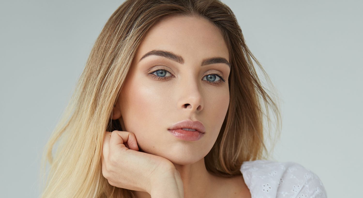 Close-up portrait of a woman with soft makeup.