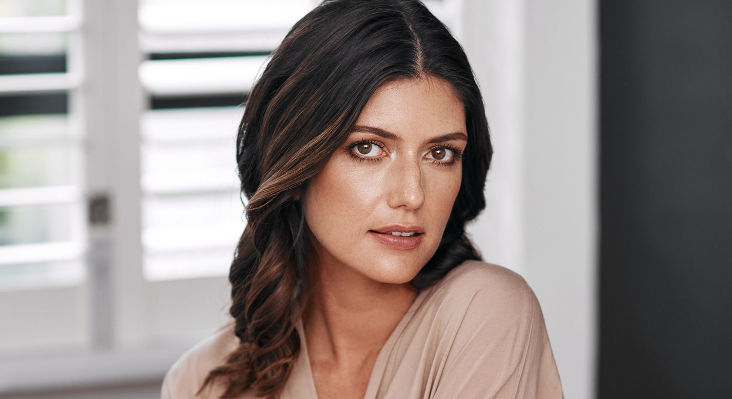 Woman with dark hair and natural makeup.